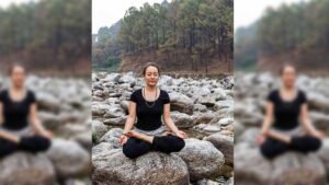 Woman sitting in Lotus by a river